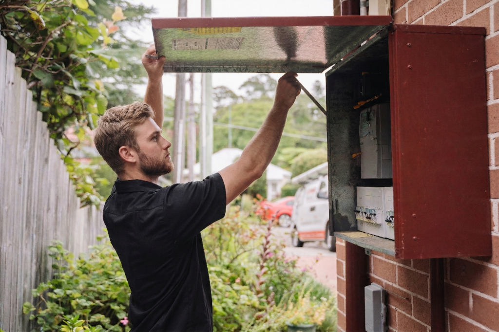Electrician installing downlights in a Kirrawee home